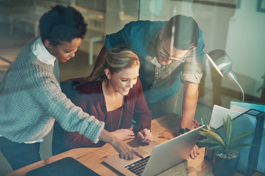 Three colleagues working on marketing automation